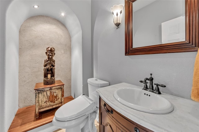 bathroom with vanity and toilet