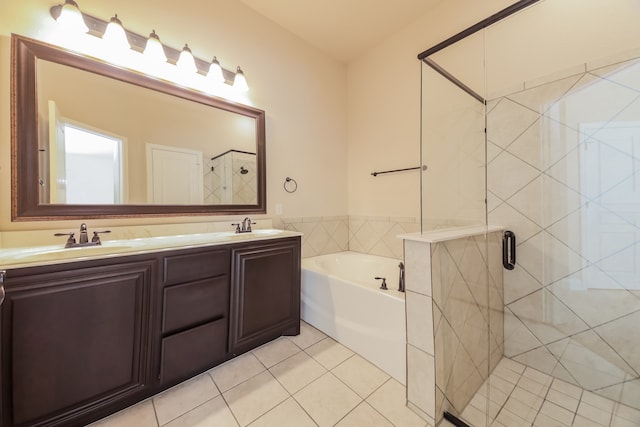 bathroom featuring tile patterned flooring, vanity, and shower with separate bathtub