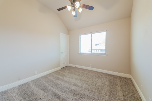 empty room featuring ceiling fan, carpet, and lofted ceiling