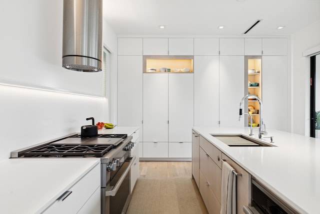 kitchen featuring white cabinets, sink, and stainless steel stove