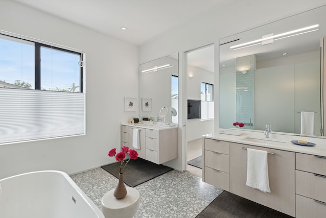 bathroom with shower with separate bathtub, vanity, and a healthy amount of sunlight