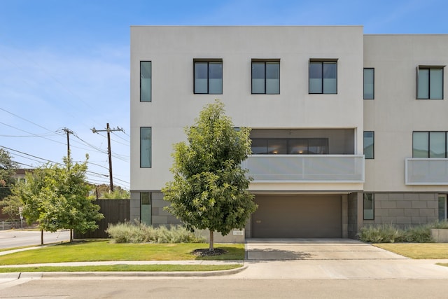 modern home with a front lawn and a garage