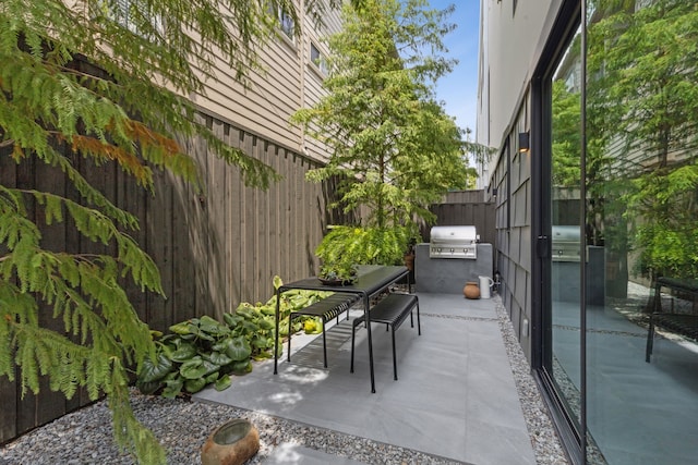 view of patio / terrace with area for grilling and a grill