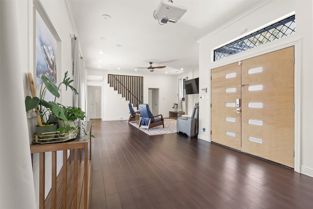 foyer featuring ceiling fan, dark hardwood / wood-style floors, and ornamental molding