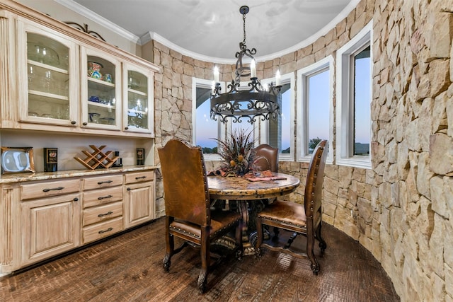 dining room featuring a chandelier, dark hardwood / wood-style floors, and crown molding