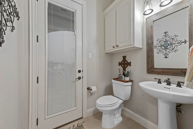 bathroom featuring tile patterned flooring, toilet, and sink