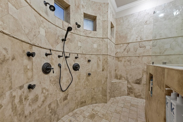 bathroom with a tile shower and ornamental molding