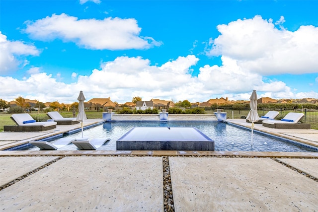 view of pool featuring pool water feature and a patio