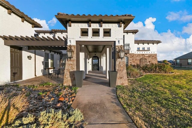 entrance to property with a lawn