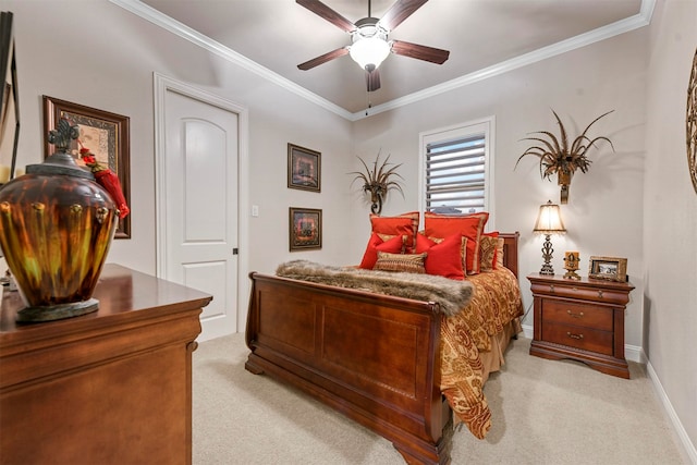 carpeted bedroom featuring ceiling fan and ornamental molding