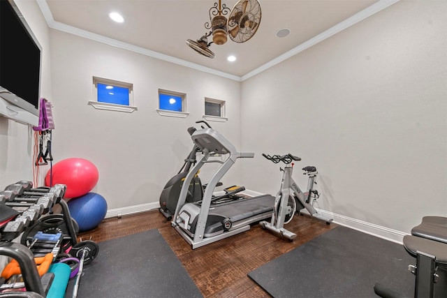 workout room with dark hardwood / wood-style flooring and crown molding