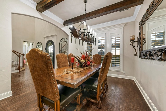 dining space featuring beam ceiling, crown molding, dark wood-type flooring, and an inviting chandelier