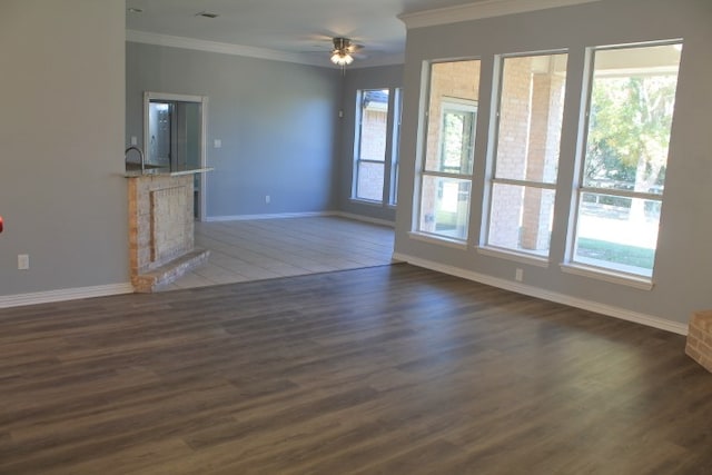 unfurnished living room featuring dark hardwood / wood-style flooring, ceiling fan, and ornamental molding