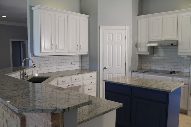 kitchen with black electric cooktop, white cabinetry, and sink