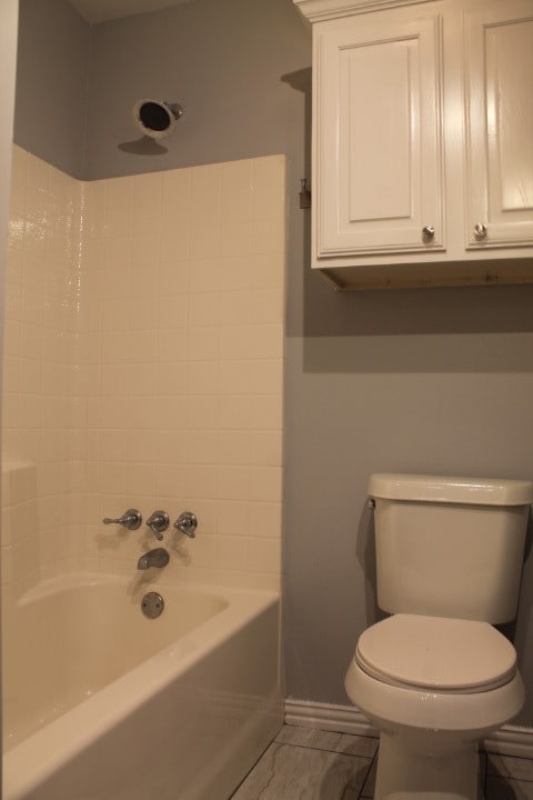 bathroom with  shower combination and toilet