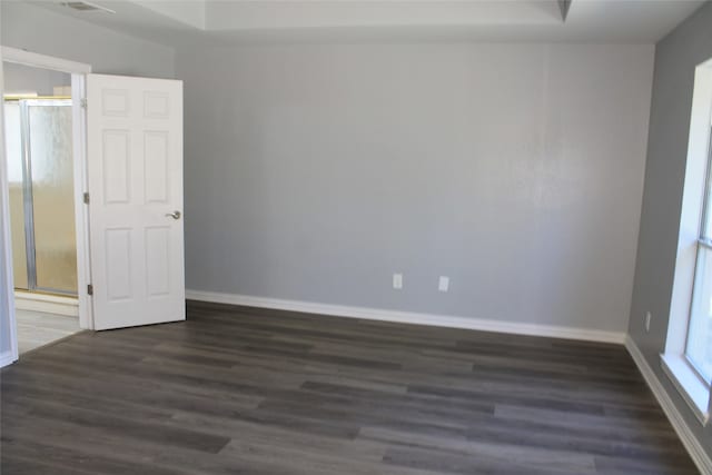 unfurnished room featuring dark hardwood / wood-style flooring