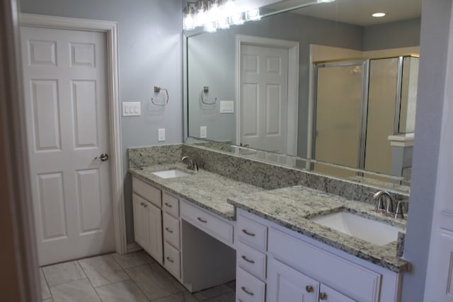 bathroom featuring vanity and an enclosed shower