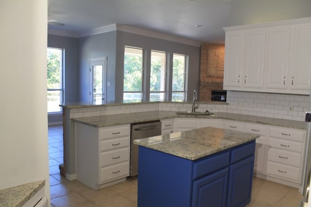 kitchen with a kitchen island, blue cabinets, and a healthy amount of sunlight