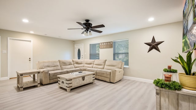 living room with ceiling fan and light hardwood / wood-style floors