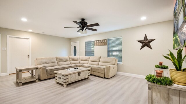 living room with ceiling fan and light hardwood / wood-style floors