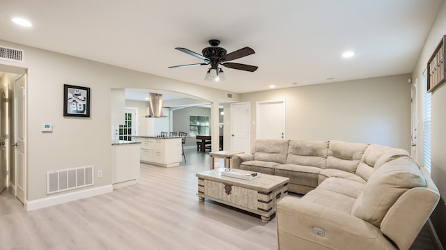 living room featuring ceiling fan and light wood-type flooring