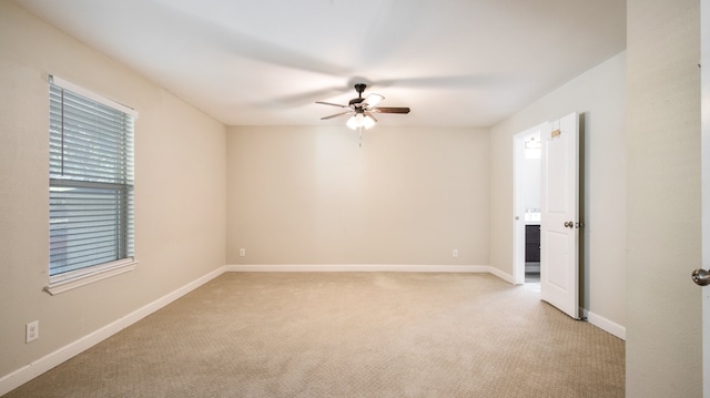 empty room with light colored carpet and ceiling fan