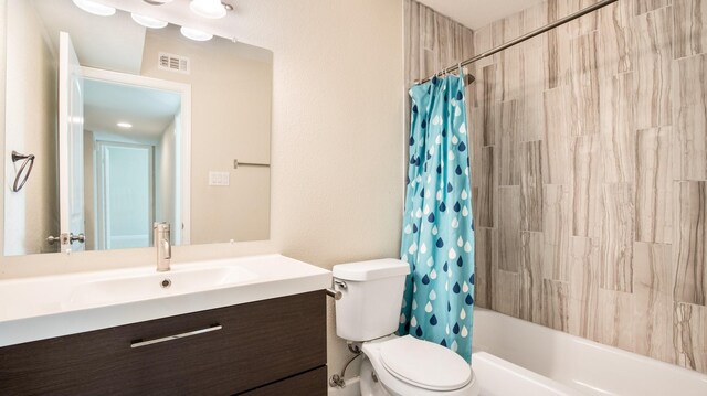 full bathroom featuring vanity, shower / bath combination with curtain, and toilet