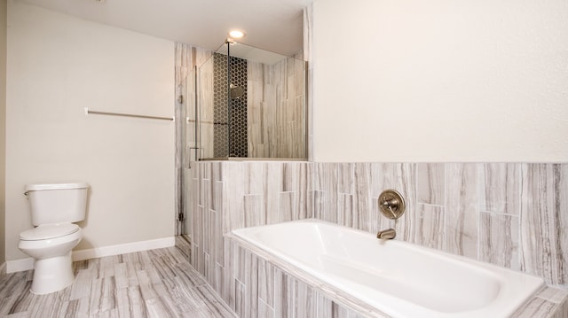 bathroom featuring wood-type flooring, shower with separate bathtub, and toilet