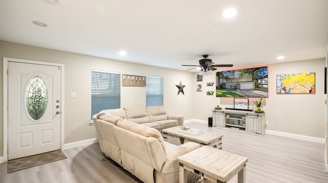 living room featuring ceiling fan and light wood-type flooring