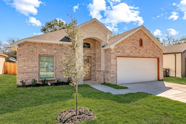 view of front of property featuring a garage, brick siding, driveway, roof with shingles, and a front yard