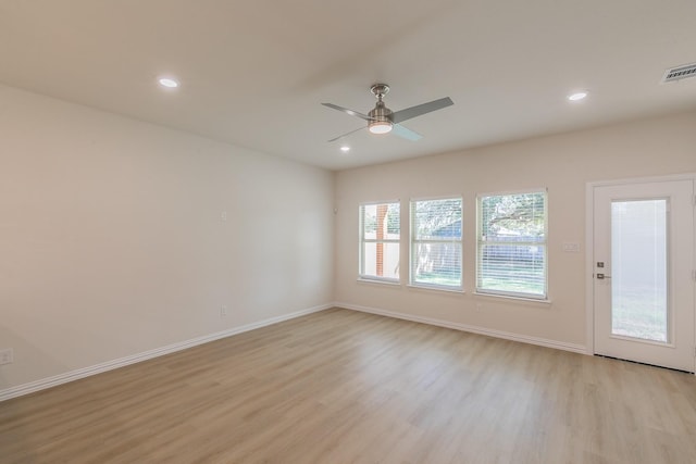 spare room with ceiling fan and light wood-type flooring