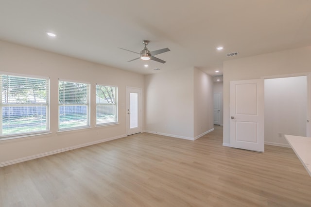 spare room featuring light wood-type flooring and ceiling fan