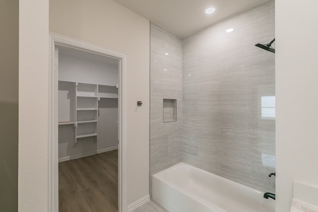 bathroom featuring wood-type flooring and bathing tub / shower combination