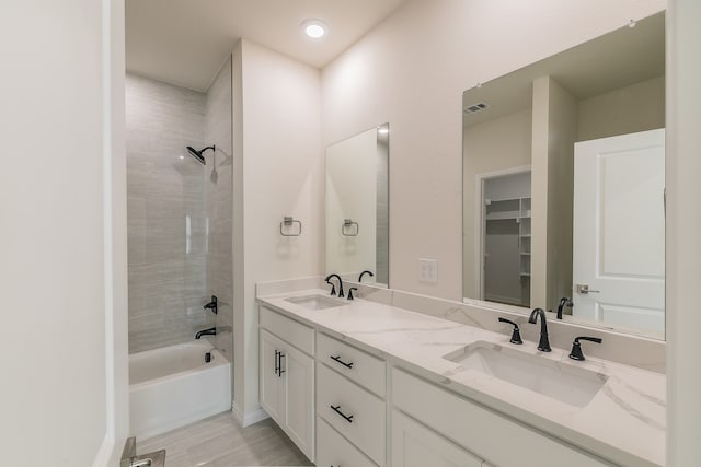 bathroom featuring hardwood / wood-style flooring, bathtub / shower combination, and vanity