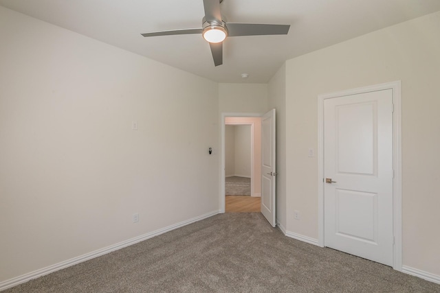 unfurnished bedroom featuring light carpet and ceiling fan