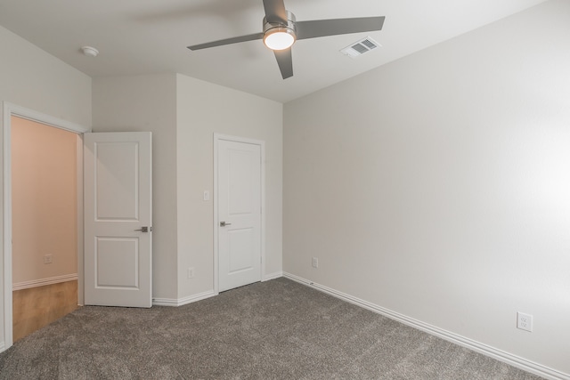 unfurnished bedroom with ceiling fan and carpet floors