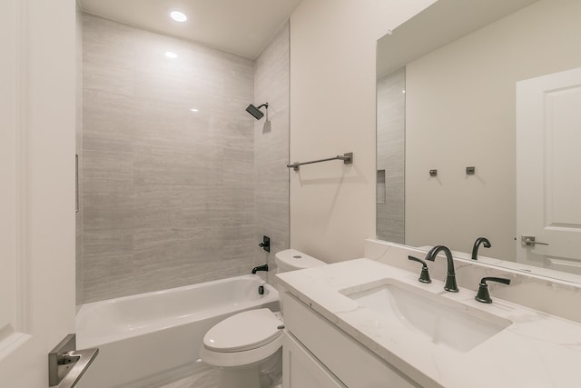 full bathroom featuring toilet, tiled shower / bath, and vanity