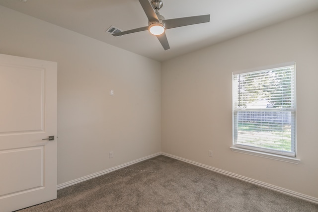 spare room featuring ceiling fan, plenty of natural light, and carpet