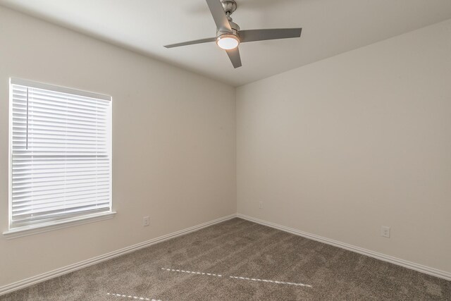 unfurnished room with ceiling fan and carpet