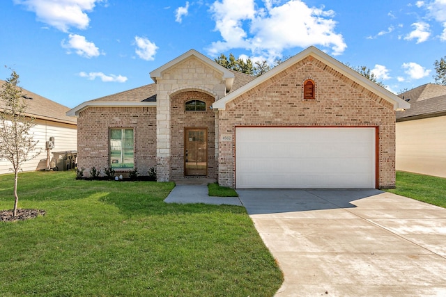 view of front of home featuring a garage and a front lawn