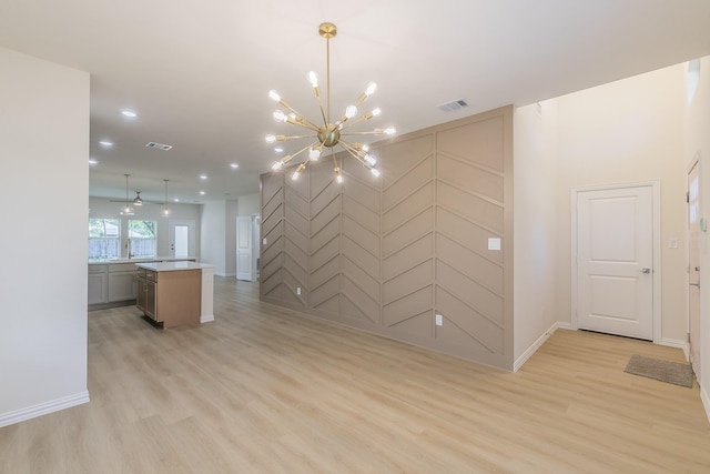 interior space featuring an accent wall, light wood-type flooring, visible vents, and recessed lighting