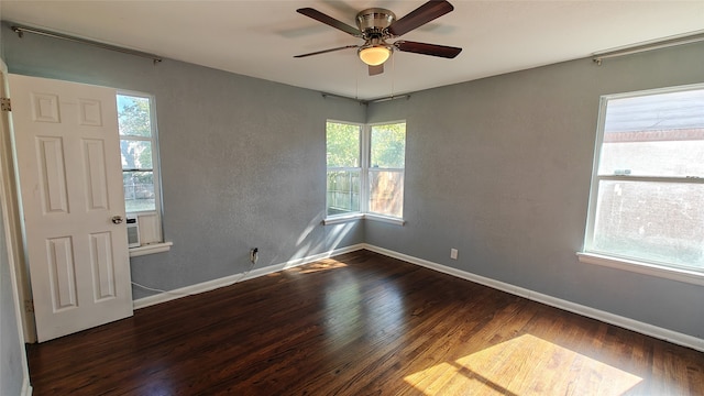 unfurnished room featuring ceiling fan and dark wood-type flooring