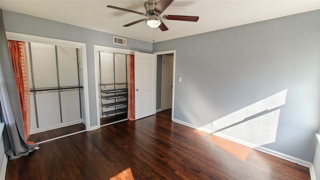 unfurnished bedroom with ceiling fan and dark hardwood / wood-style flooring