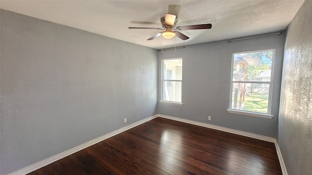 spare room featuring dark hardwood / wood-style floors and ceiling fan