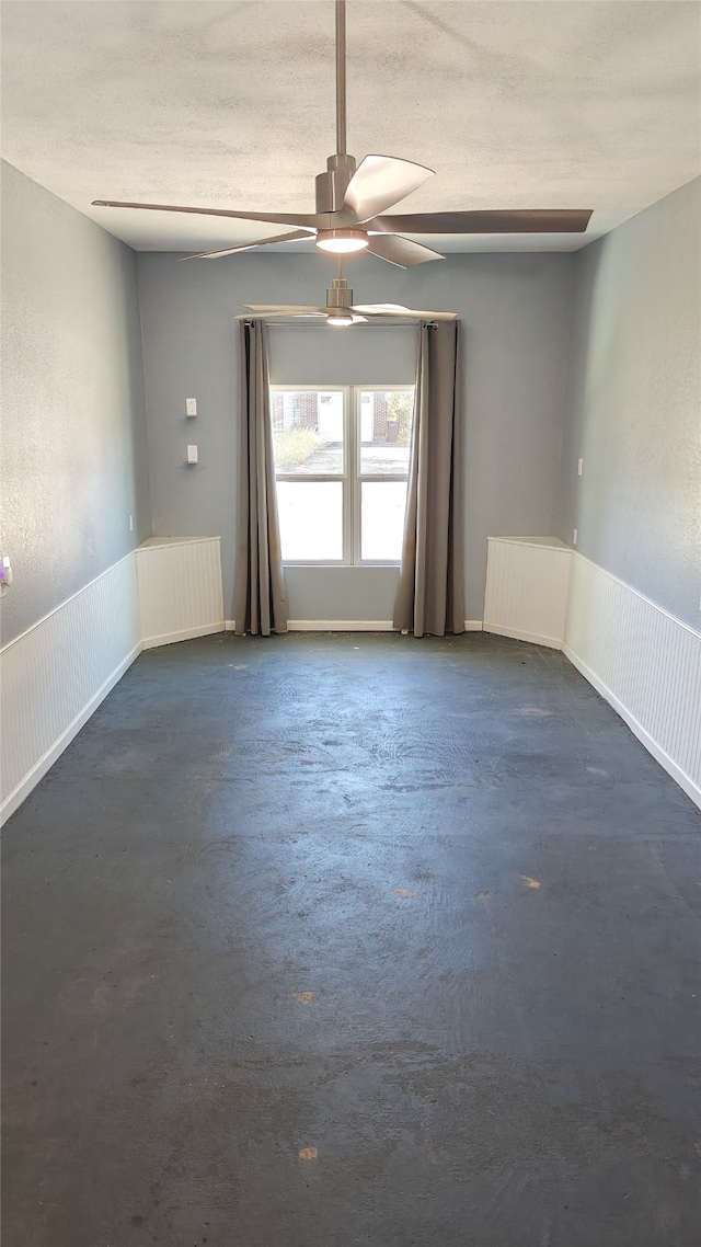 spare room with ceiling fan, radiator heating unit, and a textured ceiling