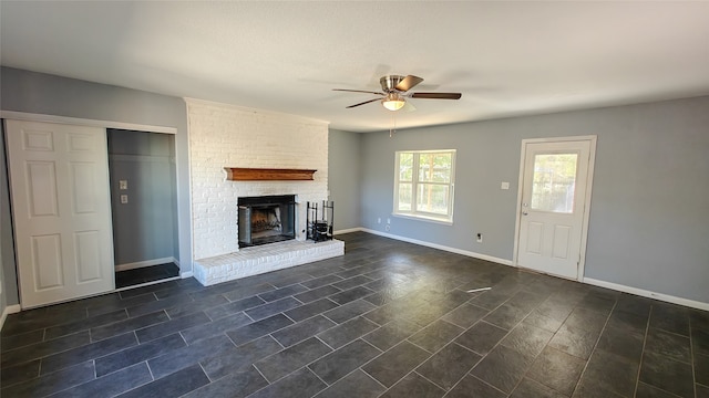 unfurnished living room with dark hardwood / wood-style floors, a brick fireplace, and ceiling fan