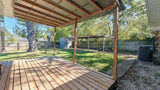 deck featuring central AC, a yard, and a storage unit