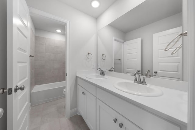 full bathroom featuring a sink, toilet, double vanity, and recessed lighting