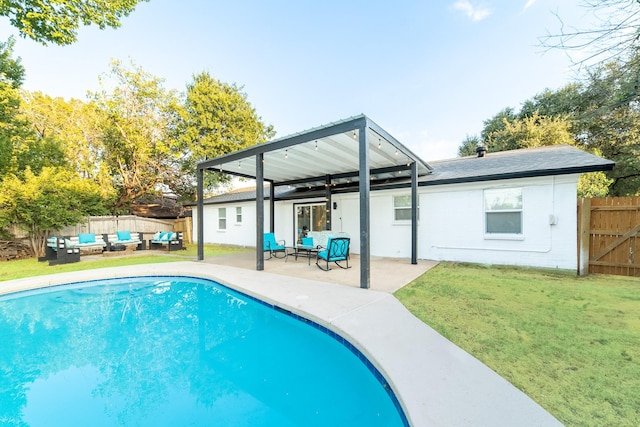 view of swimming pool featuring an outdoor living space, a patio area, and a yard