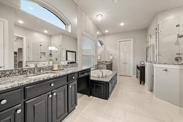 bathroom with tile patterned floors, vanity, and shower with separate bathtub